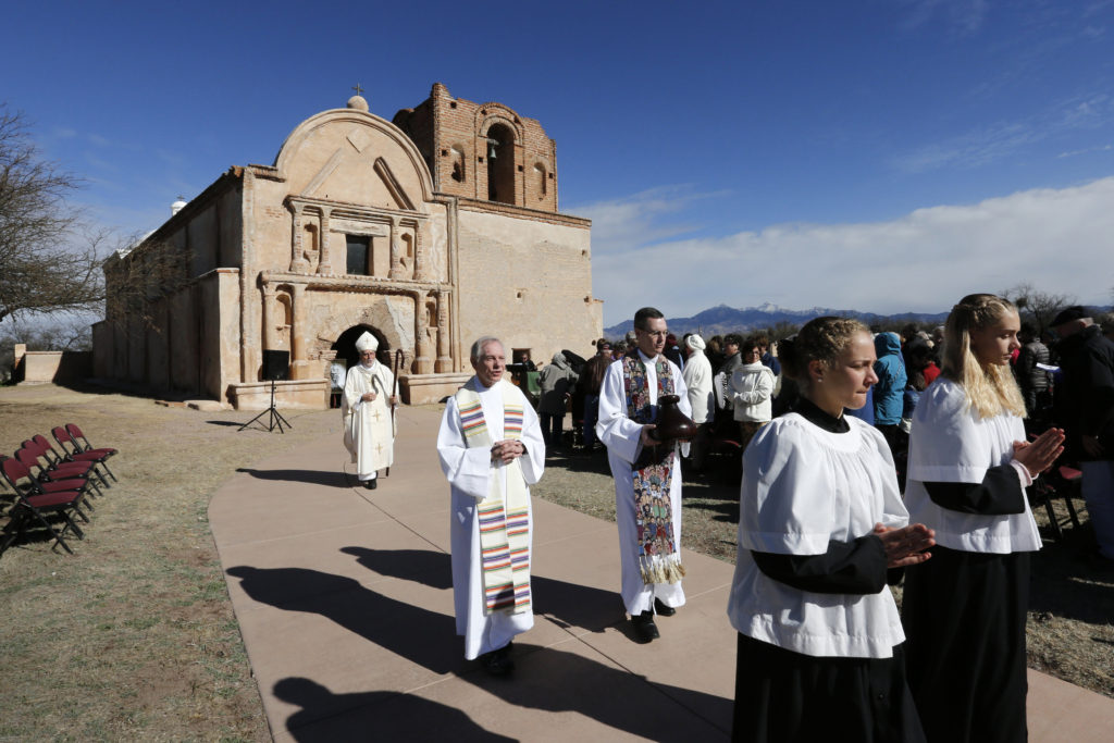 Bishop Gerald Kicanas of Tucson, Ariz., walks with his crosier after celebrating Mass outside the mission at Tumacacori National Historical Park in Tumacacori, Ariz., Jan. 10. The Mass was part of the park's Kino Legacy Day marking the 325th anniversary of the Jesuit missionary's first visit to an O’odham village there. (CNS photo/Nancy Wiechec) 