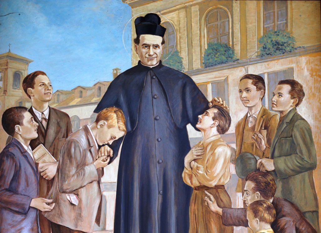 An mural showing St. John Bosco and boys is seen in a courtyard of the Sanctuary of Our Lady of Help of Christians in Turin, Italy. The sanctuary was the site of St. Bosco's home for poor and abandoned boys. (Paul Haring/CNS)