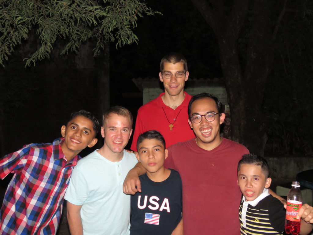 Vinhson Nguyen, second from right, poses with fellow seminarians and children he served in Central America. (courtesy photo)