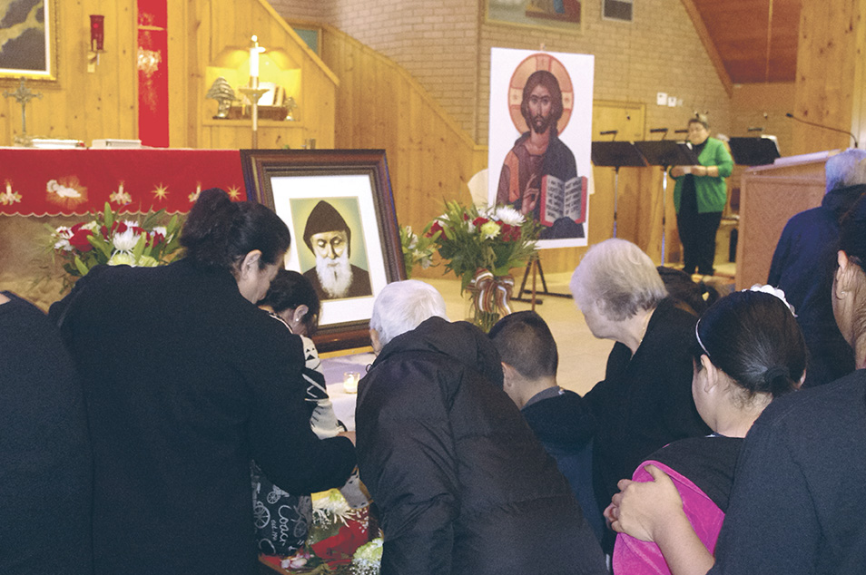 Faithful Catholics venerate the relics of St. Charbel, a 19th-century Lebanese monk who’s been credited with thousands of miracles since his death. His relics were displayed at St. Joseph Maronite Catholic Church Jan. 15-17 as part of a nationwide tour commemorating the 50th anniversary of his beatification. (Joyce Coronel/CATHOLIC SUN)