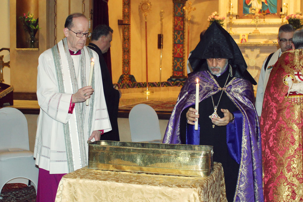 Bishop Thomas J. Olmsted of the Catholic Diocese of Phoenix and the Archbishop Hovnan Derderian of the Armenian Apostolic Church’s Western Diocese hold candles to pray for Christian Unity at St. Apkar Armenian Apostolic Church in Scottsdale. (Photo courtesy of St. Apkar Armenian Apostolic Church)