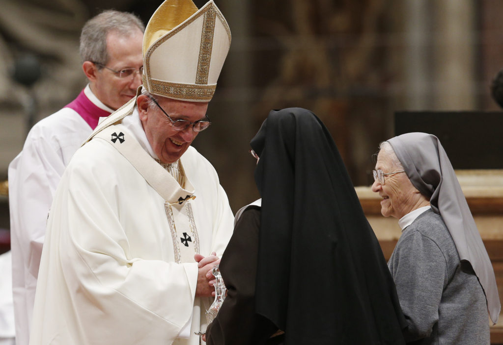 Pope Francis accepts offertory gifts from nuns as he celebrates a Mass with religious in St. Peter's Basilica at the Vatican Feb. 2. The Mass concluded the Year of Consecrated Life. (Paul Haring/CNS)