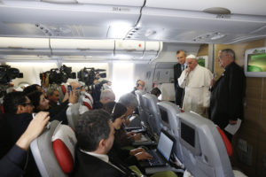 Pope Francis greets journalists aboard his flight to Havana Feb. 12. Traveling to Mexico for a six-day visit, the pope is stopping briefly in Cuba to meet with Russian Orthodox Patriarch Kirill of Moscow at the Havana airport. (CNS photo/Paul Haring) 