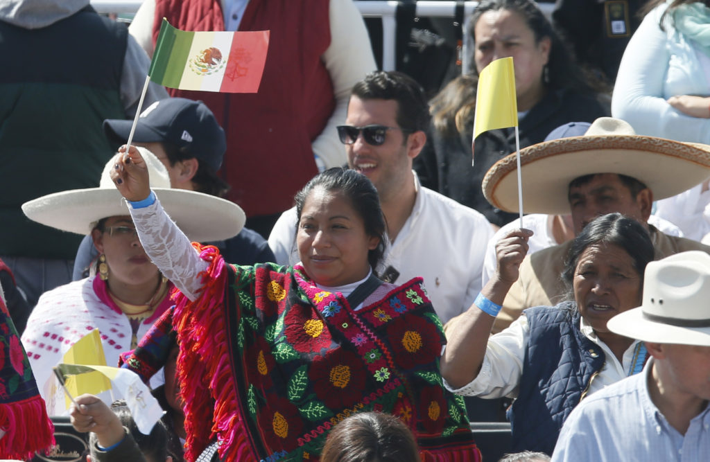 People wave the flags of Mexico and the Vatican as they wait for Pope Francis' arrival to celebrate Mass in Ecatepec near Mexico City Feb. 14. (CNS photo/Paul Haring)