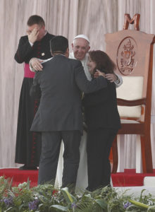 Pope Francis embraces Humberto and Claudia Gomez, who are married civilly but not in the church, during a meeting with families at the Victor Manuel Reyna Stadium in Tuxtla Gutierrez, Mexico, Feb. 15. (CNS photo/Paul Haring) 