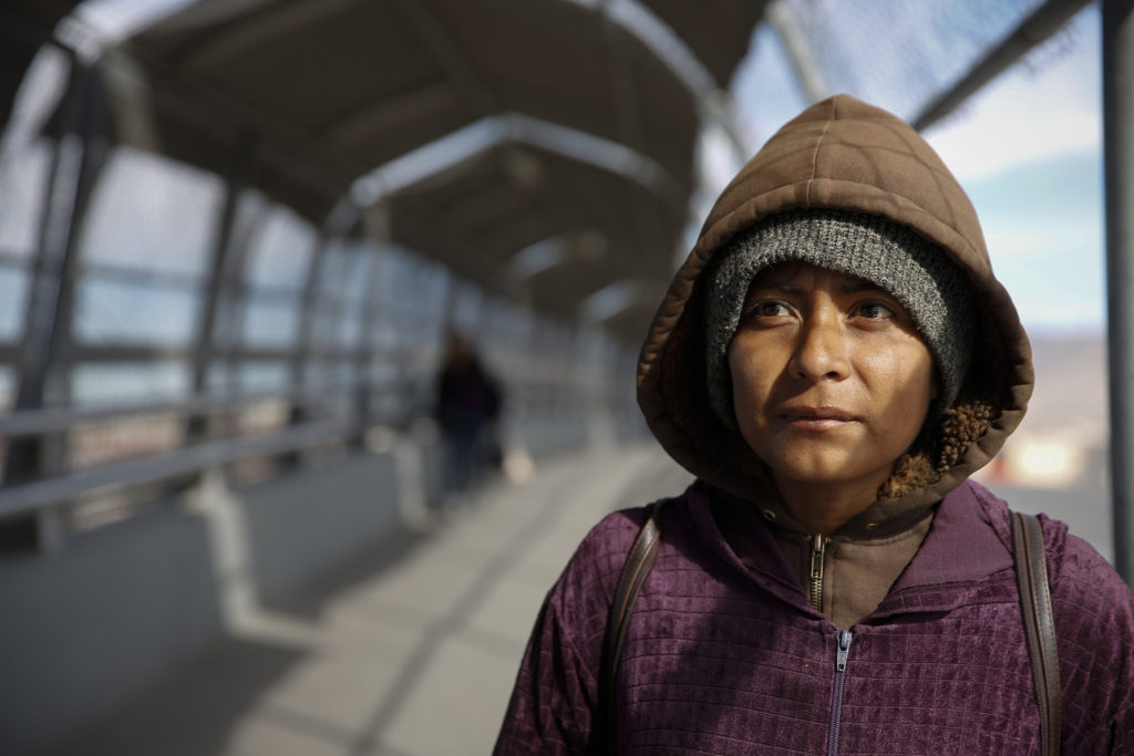 Diana Martinez stands on the bridge linking El Paso, Texas, and Juarez, Mexico, at the Paso del Nortre port of entry Feb. 15. She had been deported from the United States and was panhandling for money so that she could return to her home state of Chiapas in Mexico. (CNS photo/Nancy Wiechec) 