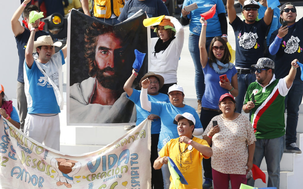 Young people hold a banner of Jesus as Pope Francis meets with youths at the Jose Maria Morelos Pavon Stadium in Morelia, Mexico, Feb. 16. (CNS photo/Paul Haring)