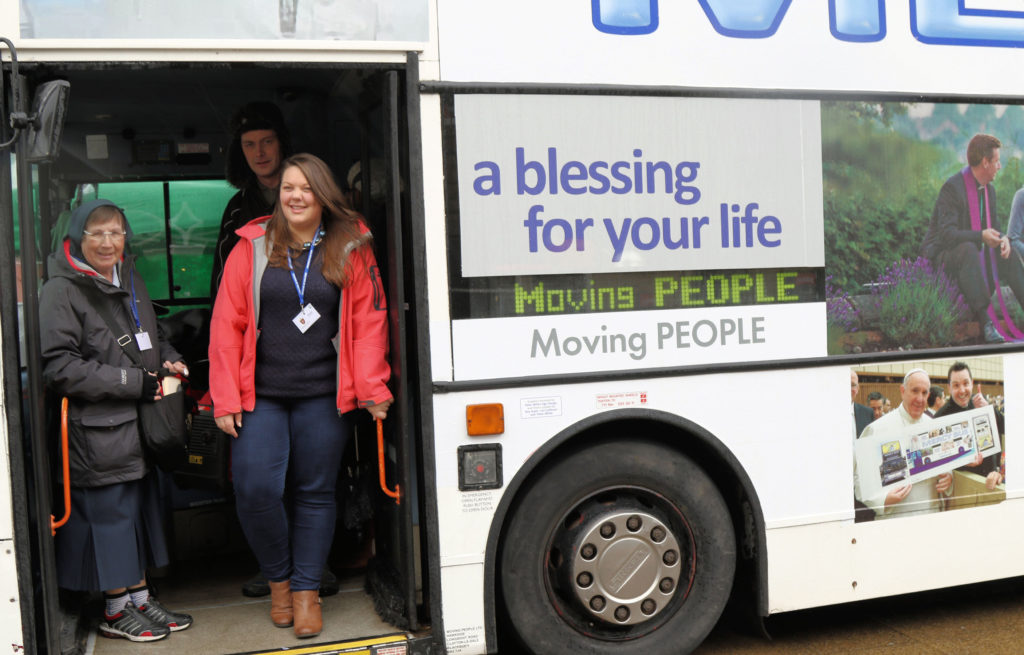 Hannah Beckford, right, a volunteer, poses for a photo on the Mercy Bus in Burnley, England, Feb. 20. Beckford said the bus has "opened the doors of the church" and that people are "coming off the bus smiling and expressing sincere thanks." (CNS photo/Simon Caldwell) 