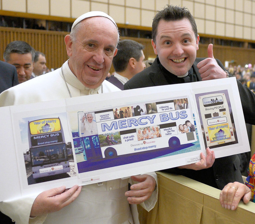In this undated photo, Pope Francis poses for a photo with Father Frankie Mulgrew, a Salford priest, who helped devise the Mercy Bus for the Year of Mercy. (CNS photo/courtesy Diocese of Salford) 