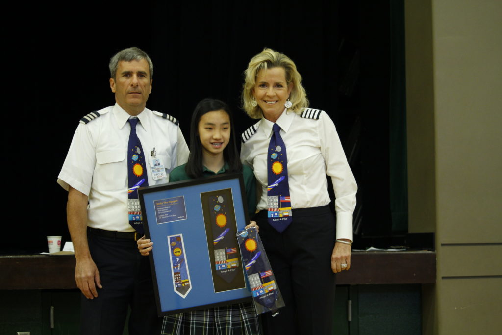Emily Thu Nguyen, a sixth-grader at Ss. Simon and Jude, poses with Southwest Airlines pilots including Erick D, who teaches the Adopt-A-Pilot curriculum to fifth-graders each year. (Ambria Hammel/CATHOLIC SUN)