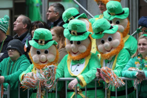 People wearing leprechaun costumes watch the 2015 St. Patrick's Day Parade in New York City. (CNS photo/Gregory A. Shemitz) 