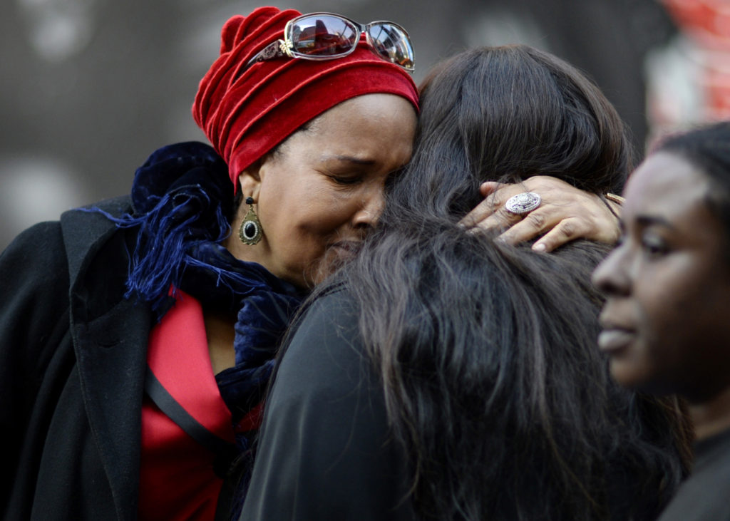 In this Oct. 22, 2015, file photo, mothers who lost their sons to police shootings hug one another during an event in New York City where names of people who died from police violence were read aloud in Times Square. (CNS photo/Justin Lane, EPA) 