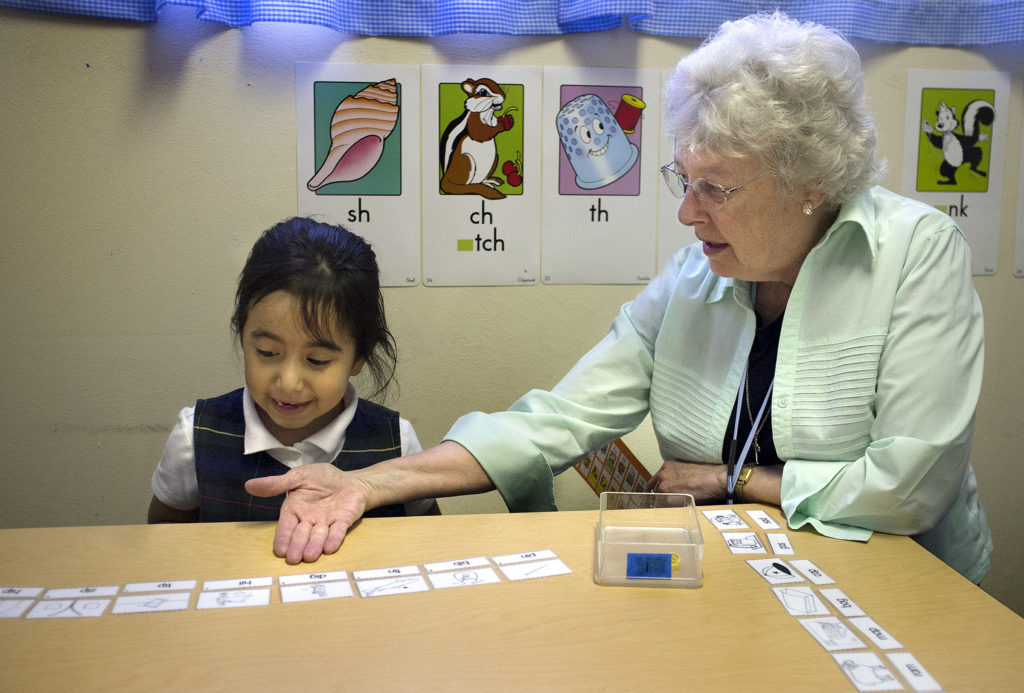 Sr. Joyce Schramm, a Sister of the Most Precious Blood, works with Holy Trinity Catholic School kindergarten student Rocio Reyes in St. Ann, Mo., in this Nov. 13, 2014, file photo. (CNS photo/Sid Hastings, St. Louis Review)