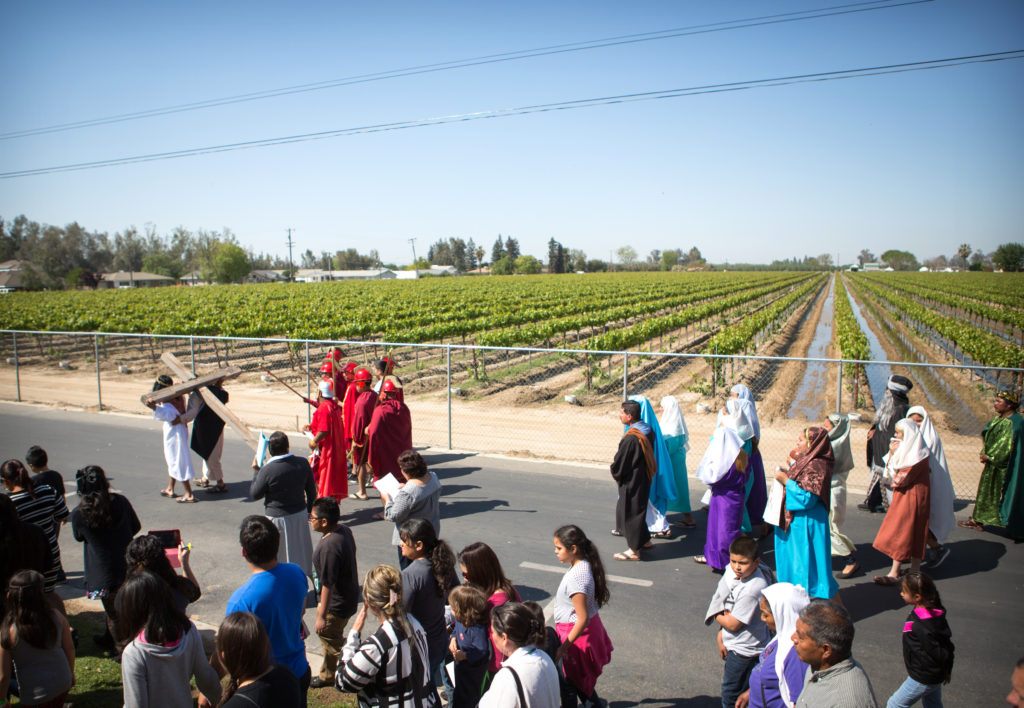 A person carrying a cross leads the Way of the Cross procession on Good Friday in the Diocese of Fresno, Calif., in this April 3, 2015, photo. The tradition of a living Stations of the Cross is especially strong in the diocese's migrant communities. (CNS photo/Rich Kalonick, Catholic Extension) 