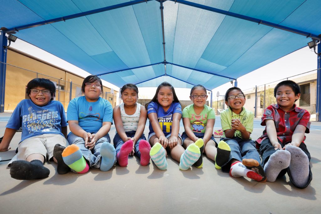 Students of St. Peter Indian Mission School sit under the shaded basketball court in 2015 that was built with help from Joe Garagiola in the Gila River Indian Community in Bapchule, Ariz. Garagiola, a legendary broadcaster and former baseball player, died March 23 at age 90 in Scottsdale, Ariz. (CNS photo/Nancy Wiechec)