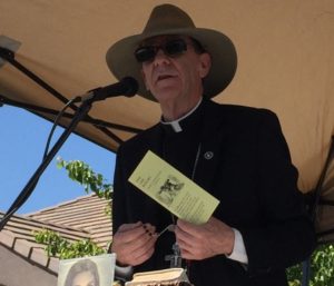 Bishop Thomas J. Olmsted leads the faithful in praying the Rosary for Life outside the Glendale Planned Parenthood on Good Friday. The day commemorating Jesus' Crucifixion fell on March 25 this year, which is also the date that normally marks the Annunciation, when Jesus entered Mary's womb. (Joyce Coronel/CATHOLIC SUN)