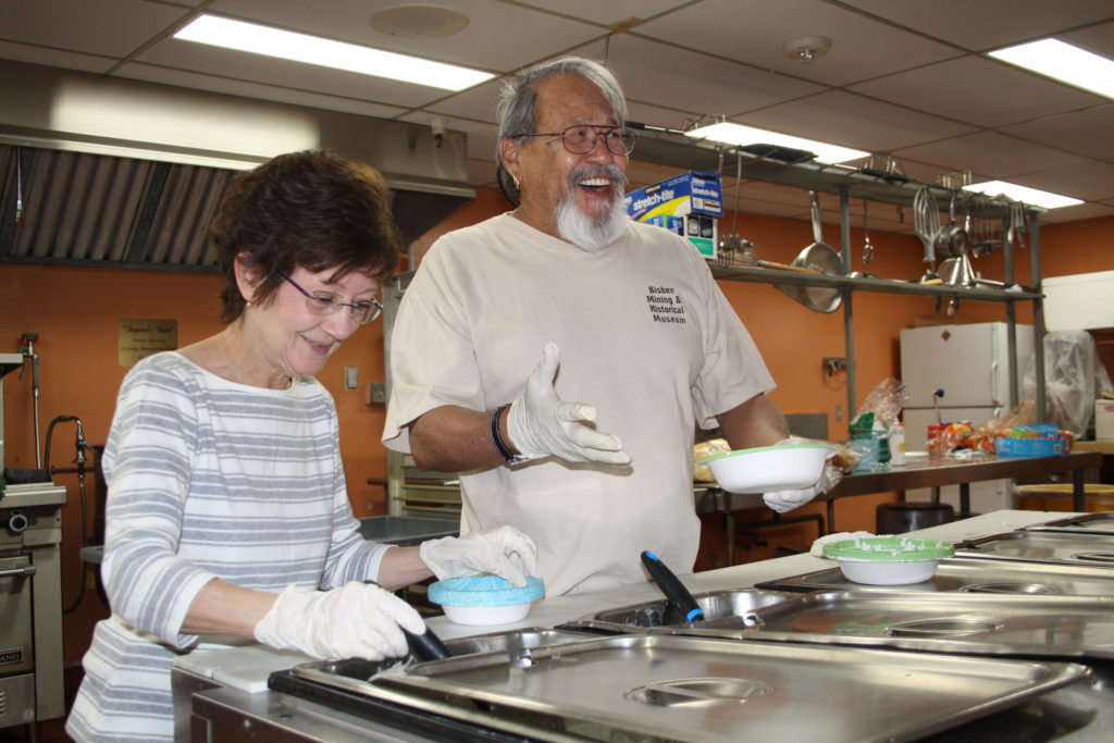 Parish volunteers welcome guests to the weekly “Soup and Bread” meal Feb. 26 at St. Jerome. A large lay effort opens the parish’s hall doors every Friday during the Year of Mercy to offer hospitality to those in need. (Ambria Hammel/CATHOLIC SUN)