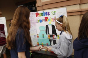 A St. Francis Xavier student purchases an item at the school's Arrupe Marketplace Feb. 19. Student vendors chose an organization and a specific need to address with their proceeds. (Ambria Hammel/CATHOLIC SUN)