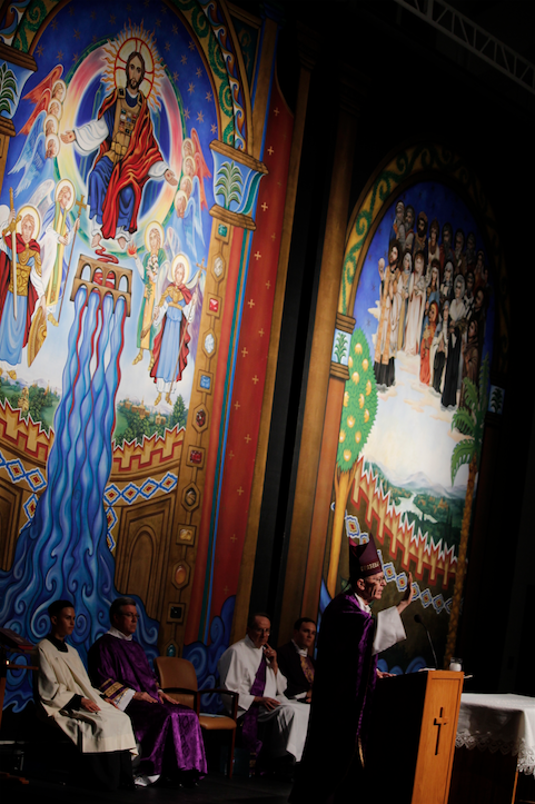 A mural depicting Jesus and angels provide a meditative backdrop as Bishop Thomas J. Olmsted for the closing Mass of the of Bishop Thomas J. Olmsted talks about ___ during (Ambria Hammel/CATHOLIC SUN)