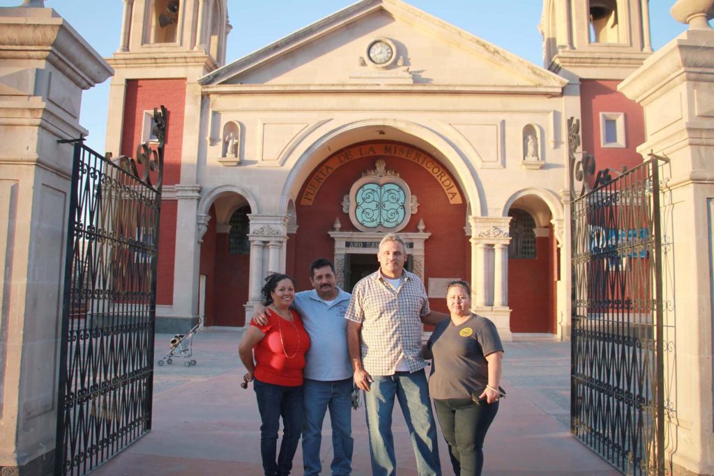 Pilgrims from Sacred Heart Parish in Phoenix, (from left to right) Luz Maríz Palma, Miguel Palma, Sergio Siller and Rosa Siller, pose in front of San Lorenzo (St. Lawrence) Parish in Ciudad Juárez. San Lorenzo is one of the parishes in that diocese with designated Holy Doors of Mercy during the Jubilee Year of Mercy. (Tony Gutiérrez/CATHOLIC SUN)