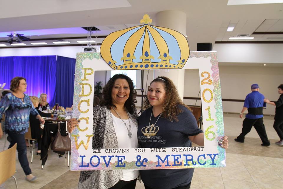 Roberta Bazaldua, left, poses behind a homemade photo frame that touts the theme of the 2016 diocesan Catholic Women's Conference. (photo from Phoenix Diocesan Council of Catholic Women Facebook page)