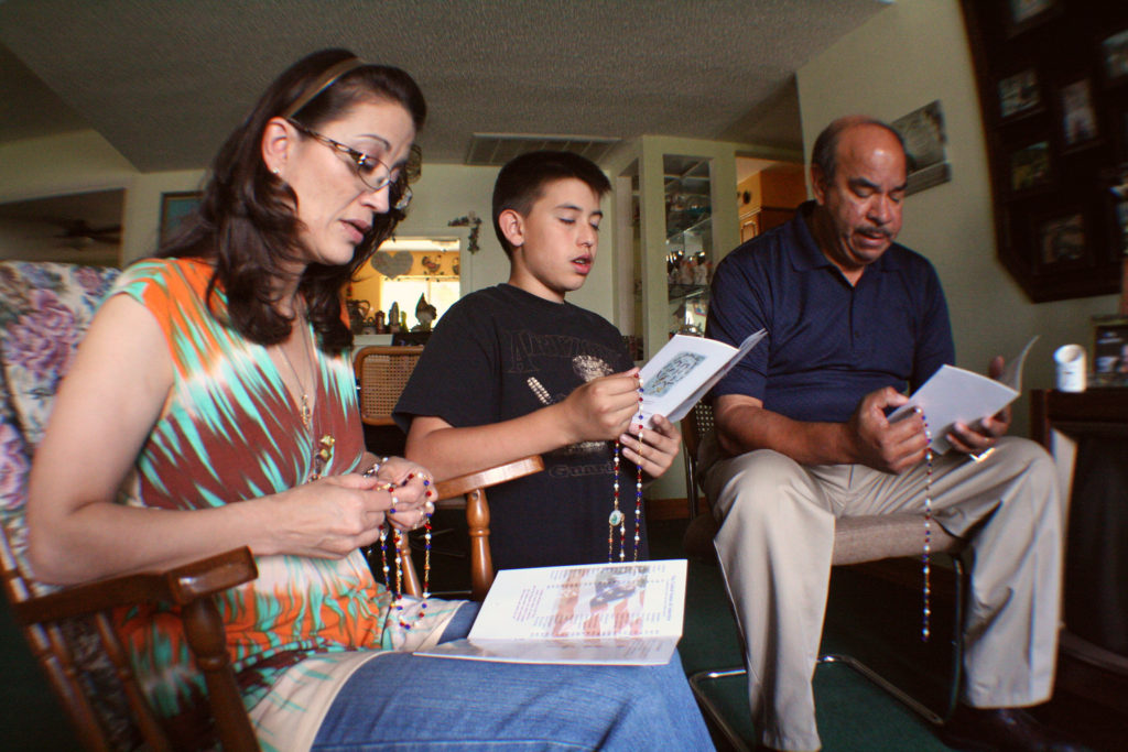 A family prays the rosary in 2012 in their Phoenix home. Pope Francis' postsynodal apostolic exhortation on the family, "Amoris Laetitia" ("The Joy of Love"), was to be released April 8. The exhortation is the concluding document of the 2014 and 2015 synods of bishops on the family. (CNS photo/J.D. Long-Garcia)