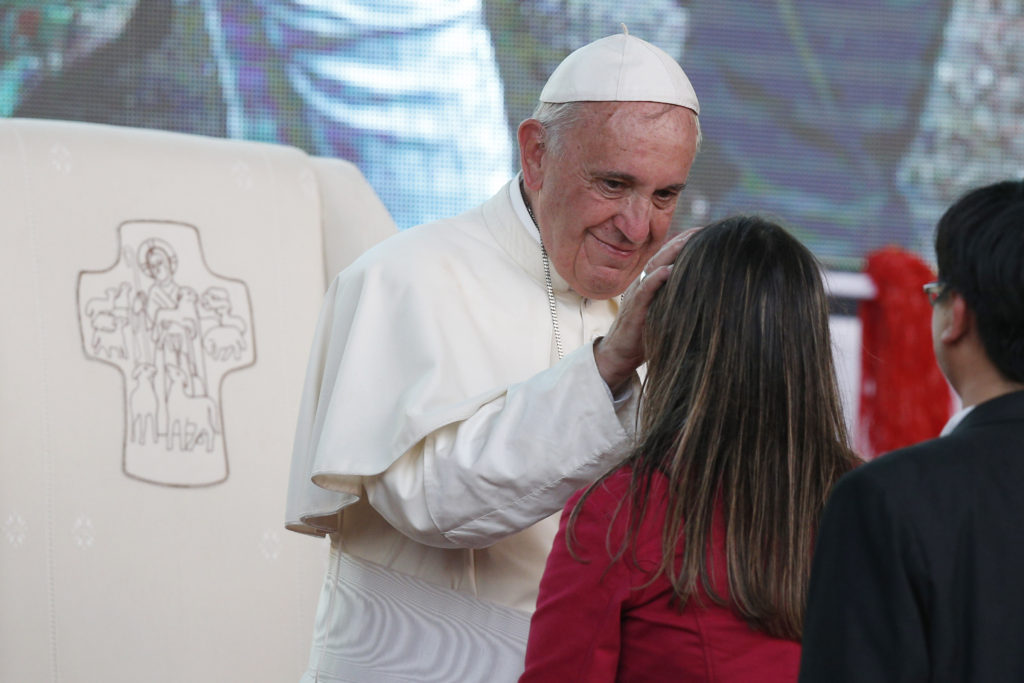 Pope Francis greets a young woman during a meeting with youths in Asuncion, Paraguay, in this July 12, 2015, file photo. Pope Francis' postsynodal apostolic exhortation on the family, "Amoris Laetitia (The Joy of Love)," was to be released April 8. (CNS photo/Paul Haring)
