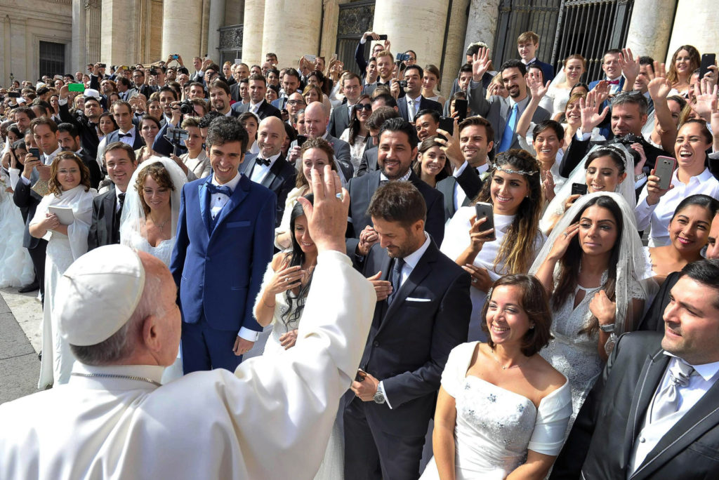 Pope Francis greets newly married couples during his general audience in St. Peter's Square at the Vatican in this Sept. 30, 2015, file photo. Pope Francis' postsynodal apostolic exhortation on the family, "Amoris Laetitia" ("The Joy of Love"), was to be released April 8. The exhortation is the concluding document of the 2014 and 2015 synods of bishops on the family. (CNS photo/L'Osservatore Romano)