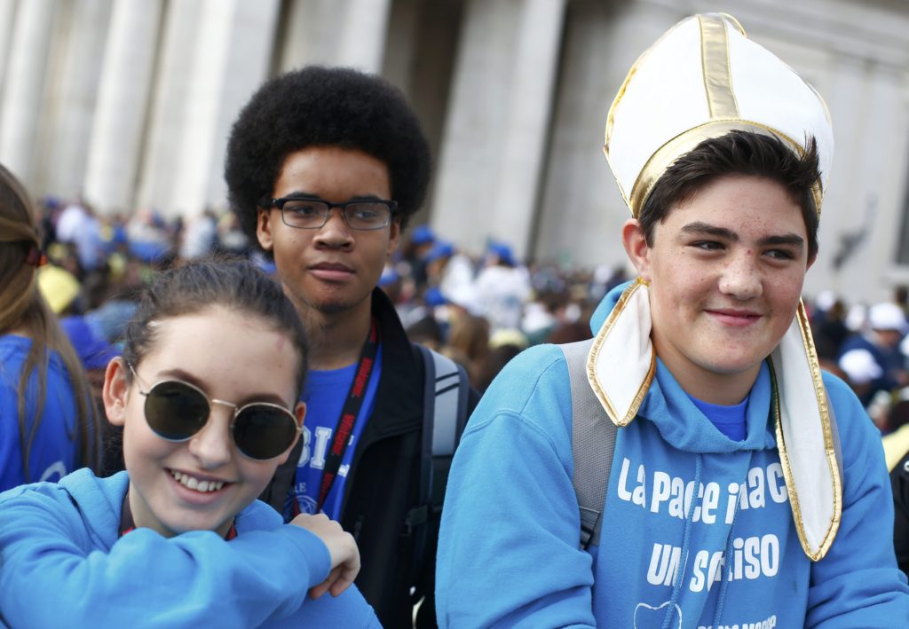 A boy wears a mock miter before Pope Francis arrives April 24 to celebrate a Mass for the Youth Jubilee in St. Peter's Square at the Vatican. (CNS photo/Tony Gentile, Reuters) 