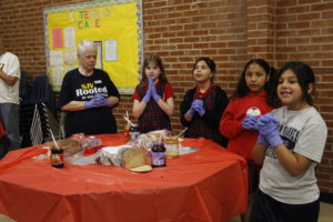 St. John Vianney third-graders, including Samantha, pray before preparing three sandwiches each for guests who are homeless and vulnerable at André House. (Ambria Hammel/CATHOLIC SUN)