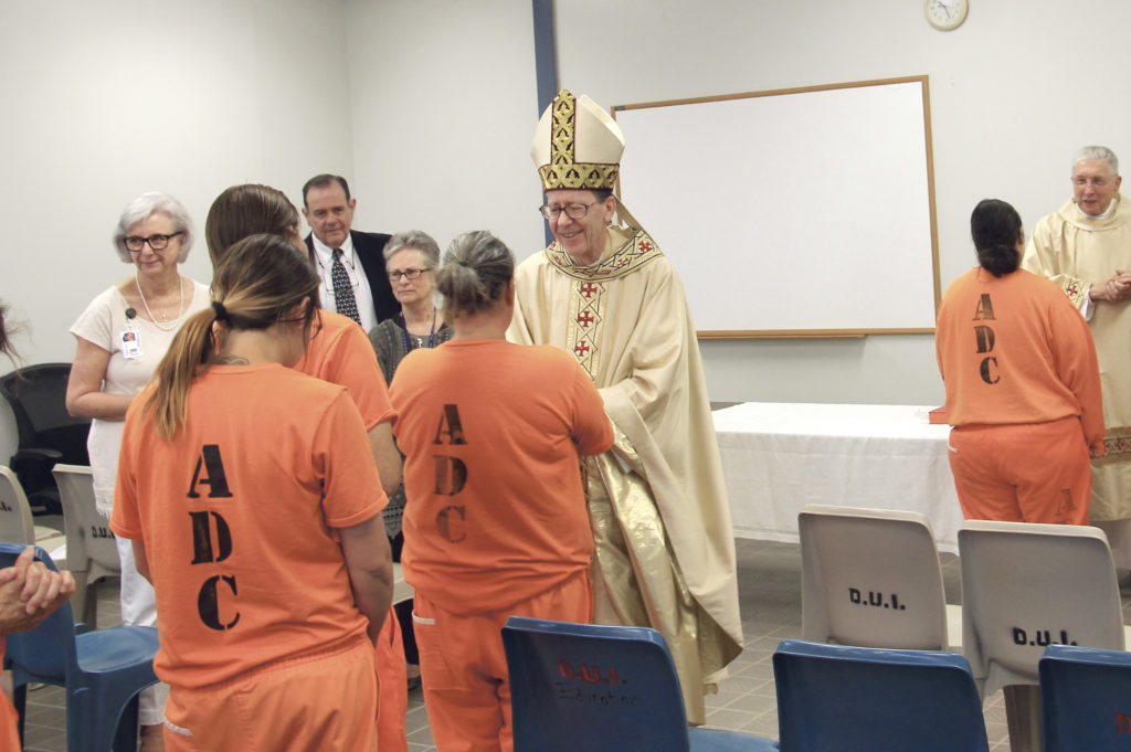 Bishop Thomas J. Olmsted greets female inmates at Easter Mass with women at Perryviille State Prison Complex following an Easter Mass March 27. Men and women in prison often write to churches hoping someone will respond and relish religious-based visits with volunteers. (Tony Gutiérrez/CATHOLIC SUN)
