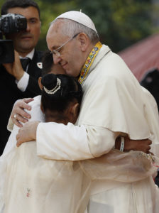 Pope Francis greets Jun Chura, 14, and Glyzelle Palomar, 12, two former street children who spoke during a meeting with young people at the University of St. Thomas in Manila, Philippines, in this Jan. 18, 2015, file photo. Palomar cried while giving her testimony, leading the pope to speak about the importance of tears. (CNS photo/Paul Haring) 