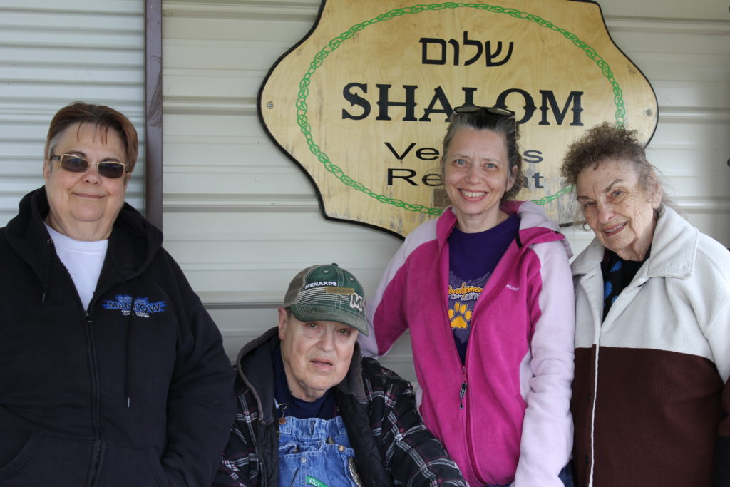 Denise Bricker, her brother, David, Anna Upah, a home health worker, and Verabeth Bricker, mother of Denise and David, are pictured April 28 in Victor, Iowa. The three women are "moms" to David, who lives with a developmental disability. (CNS photo/Barb Arland-Fye, The Catholic Messenger) 