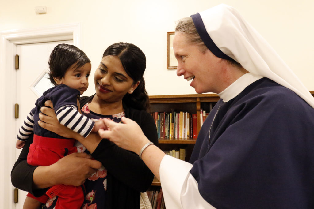 Rohini Brijlall holds her three-month-old son Zakarya as Sister Mary Elizabeth, vicar general of the Sisters of Life, talks with the child May 4 at the religious community's Holy Respite residence in the Hell's Kitchen neighborhood of New York City. Holy Respite serves as a home and support center for pregnant women in crisis and new mothers. (CNS photo/Gregory A. Shemitz) 