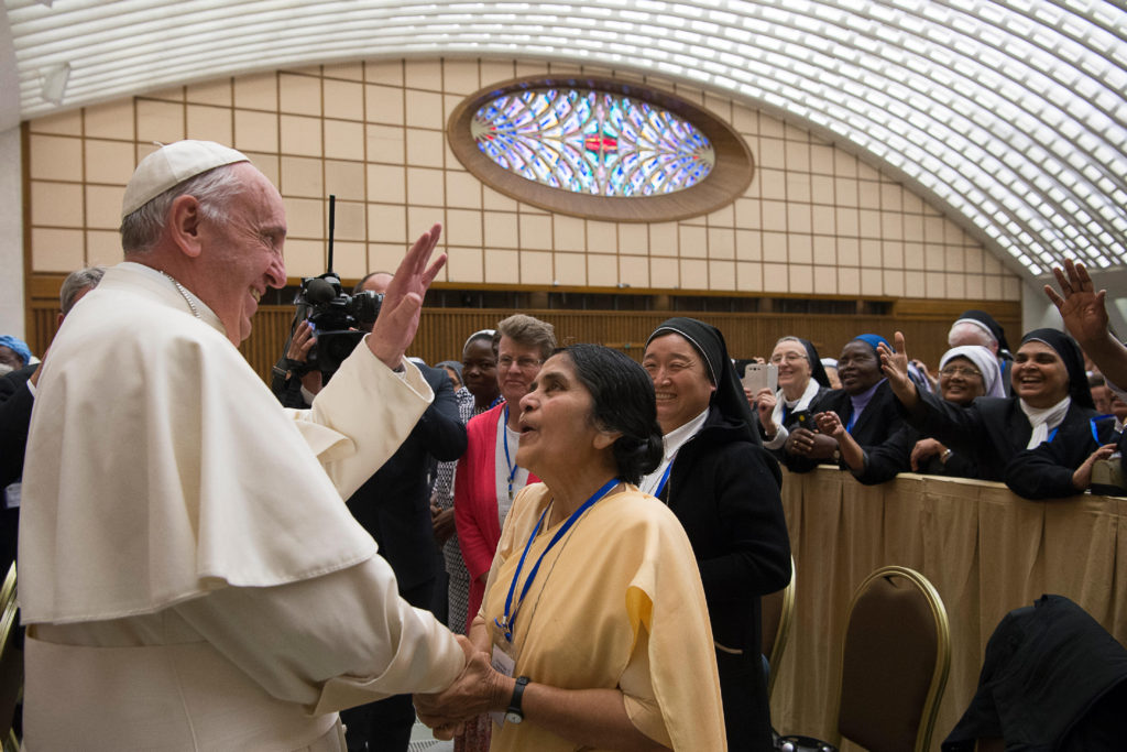 Pope Francis greets a nun during an audience with the heads of women's religious orders in Paul VI hall at the Vatican May 12. During a question-and-answer session with members of the UISG, the pope said he was willing to establish a commission to study whether women could serve as deacons. (CNS photo/L'Osservatore Romano) See POPE-UISG May 12, 2016.