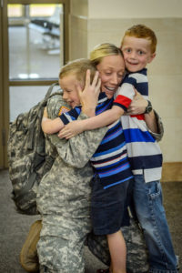 North Dakota National Guard Capt. Nicolette Daschendorf, of the Fargo-based 231st Brigade Support Battalion Logistical Support Element (BSB LSE), hugs her sons after arriving at Bismarck Airport on July 21, 2015 after a nearly yearlong deployment overseas. The group of fifteen Soldiers arrived on two separate flights this evening, with twelve landing at Fargo’s Hector International Airport and the other three at Bismarck Airport. Daschendorf served as the unit’s commander. (U.S. Army National Guard photo by: Staff Sgt. Brett Miller/Released)