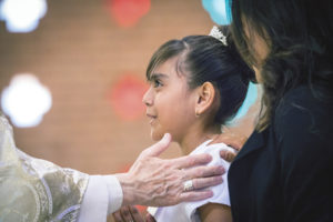 Bishops and priests with special permission are confirming thousands of children throughout the Easter Season and beyond, including Mayrim Loredo-Patchen from Most Holy Trinity Parish. (Billy Hardiman/CATHOLIC SUN)