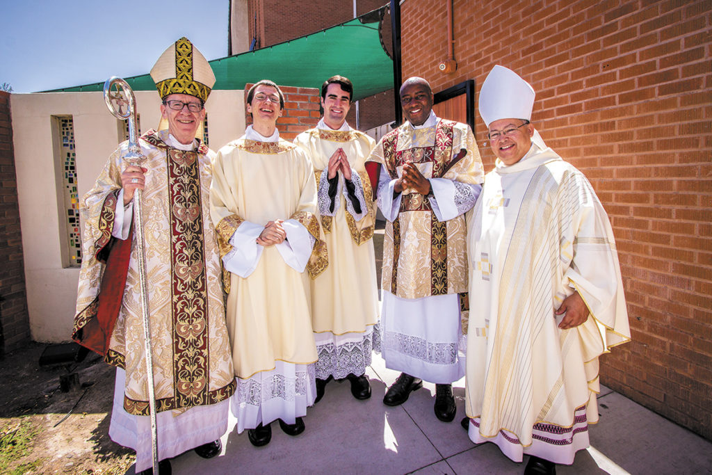 Bishop Thomas J. Olmsted and Auxiliary Bishop Eduardo A. Nevares pose with (from left to right) Dcns. David Loeffler, Ryan Lee and Sheunesu Bowora shortly after their May 31, 2015 diaconal ordination. (File Photo/CATHOLIC SUN)