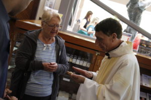 Fr. Bernard Olszewski, JCL, a priest with Cross Catholic Outreach and a Missionary of Mercy commissioned by Pope Francis, blessed a holy object at St. Paul Parish April 17. He later spent an hour offering pardon and peace via the confessional. (Ambria Hammel/CATHOLIC SUN)