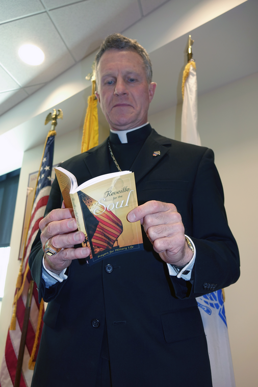 Military Services Archbishop Timothy P. Broglio peruses one of 700 copies of Liguori’s Reveille for the Soul, donated by Liguori Publications to serve the pastoral needs of recruits. (Photo courtesy of the Archdiocese for the Military Services, USA)