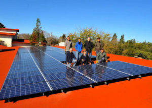 Parishioners of St. Thomas Aquinas in Palo Alto, Calif., pose next to solar panels in this undated 2015 file photo. The Archdiocese of San Francisco is launching a "Laudato Si'" initiative to help parishes respond to Pope Francis' 2015 encyclical and form "care for creation" teams. (CNS photo/courtesy St. Thomas Aquinas Parish)