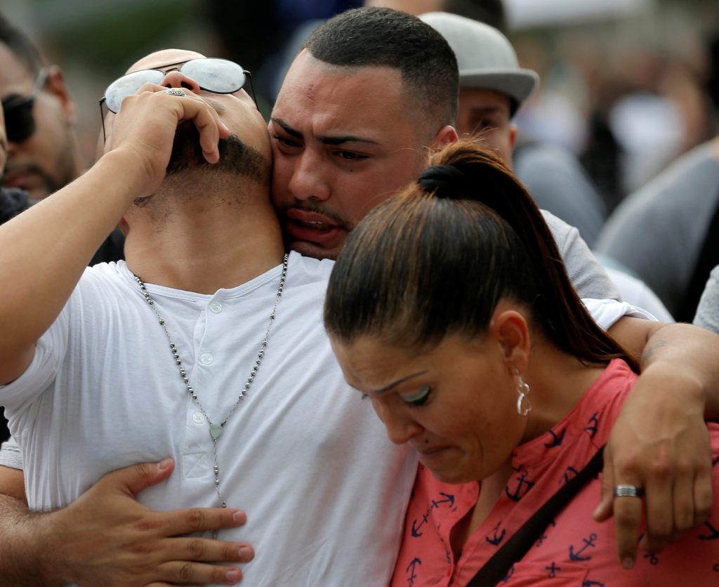 Mourners grieve at a June 13 vigil for the victims of the mass shooting at the Pulse gay nightclub in Orlando, Fla. A lone gunman, pledging allegiance to the Islamic State terrorist group, killed 49 people early June 12 at the nightclub. (CNS photo/Jim Young, Reuters) 