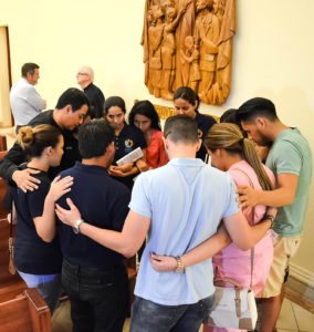 Father Jorge Torres, director of vocations for the Diocese of Orlando, Fla., prays with young people who participated in the "Vigil to Dry Tears" June 13 at St. James Cathedral in Orlando. Father Torres is among the Orlando diocesan priests lending a hand in counseling families and friends of victims of the June 12 massacre at Pulse nightclub in Orlando. (CNS photo/Andrea Navarro, Florida Catholic)