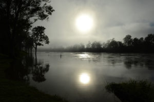 Early morning sun rises through the fog in 2013 over the swollen Brisbane River in Australia. During the last year, Australian parishes and schools have integrated "green" practices into everyday life to reduce energy consumption in response to Pope Francis' environmental encyclical. (CNS photo/Dan Peled, EPA)