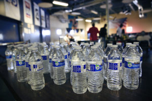 Water bottles are set out for the taking at the Society of St. Vincent de Paul dining hall in downtown Phoenix June 4 when the temperature reached 115 degrees. Open regularly for breakfast and lunch, the hall extends its hours into the late afternoon and night to provide needed refuge for the homeless during the Phoenix metro area's periods of excessive heat. (CNS photo/Nancy Wiechec) 