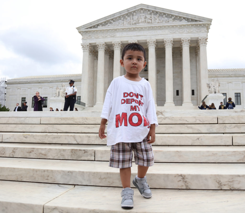 A boy wearing a T-shirt reading "Don't Deport My Mom" stands outside the U.S. Supreme Court in Washington June 23 after the justices issued a 4-4 ruling on President Barack Obama's executive actions on immigration. The split decision leaves in place a lower court ruling that blocked Obama's policies. (CNS photo/Andrew Gombert, EPA) 