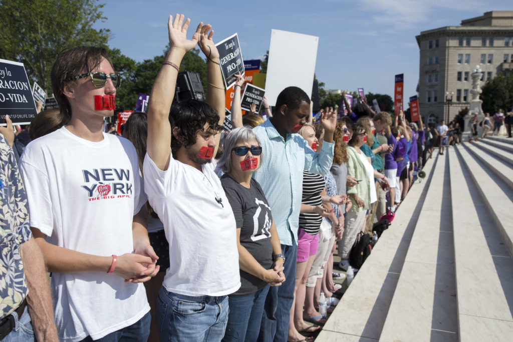 Pro-life supporters pray at the steps of the U.S. Supreme Court June 27 during protests in Washington. In a 5-3 vote that day, the U.S. Supreme Court struck down restrictions on Texas abortion clinics that required them to comply with standards of ambulatory surgical centers and required their doctors to have admitting privileges at local hospitals. (CNS photo/Michael Reynolds, EPA)