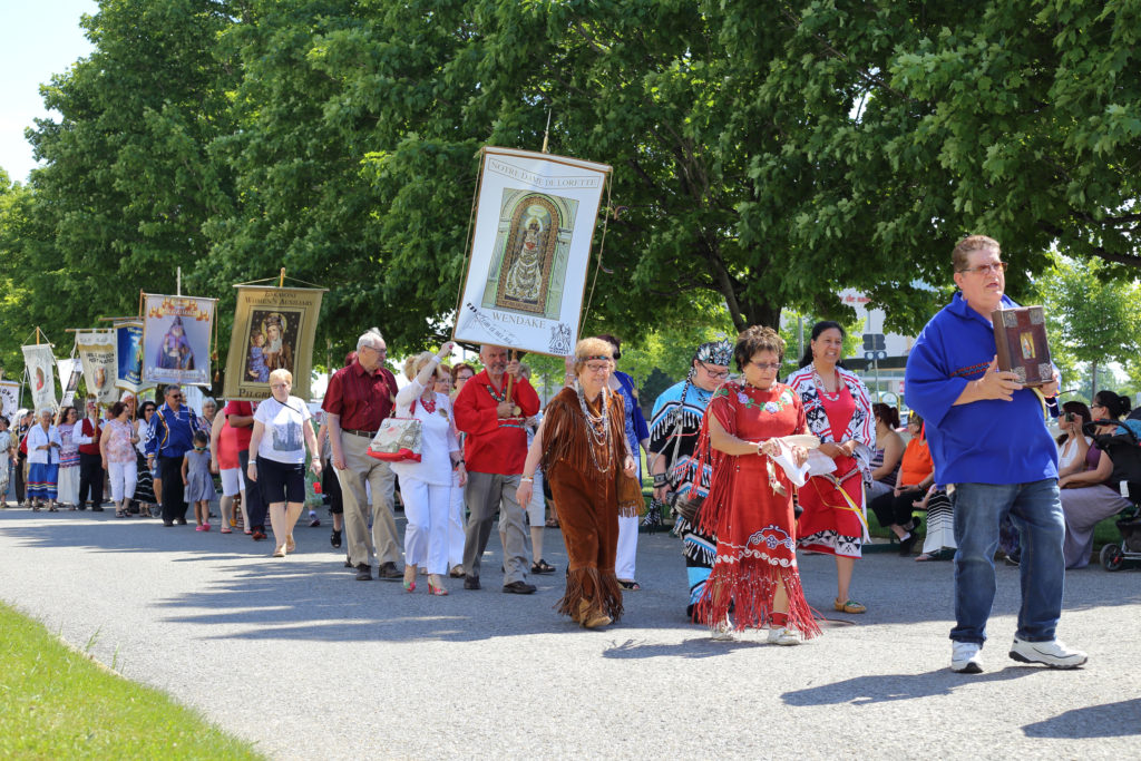 Native people from the Huron-Wendat First Nation community in Quebec City display traditional vestments outside the Basilica of Sainte Anne-de-Beaupre in Quebec June 26. (CNS photo/Philippe Vaillancourt, Presence)