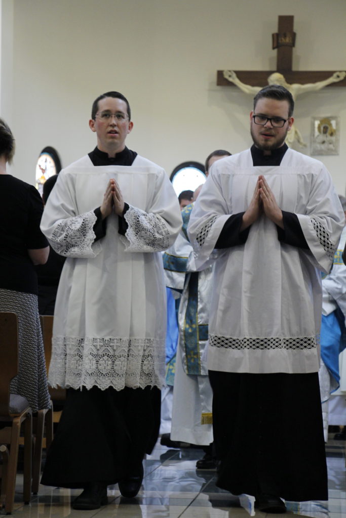 Nathaniel Glenn and Gabriel Terrill process out of Mass at the Diocesan Pastoral Center June 11 where they were admitted as candidates for ordination.  (Ambria Hammel/CATHOLIC SUN)