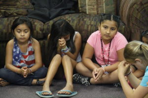 Girls join in closing prayer during "Mary's Mantle," a brief time of prayer and discussion for the girls involved with Totus Tuus at Most Holy Trinity June 17. (Ambria Hammel/CATHOLIC SUN)